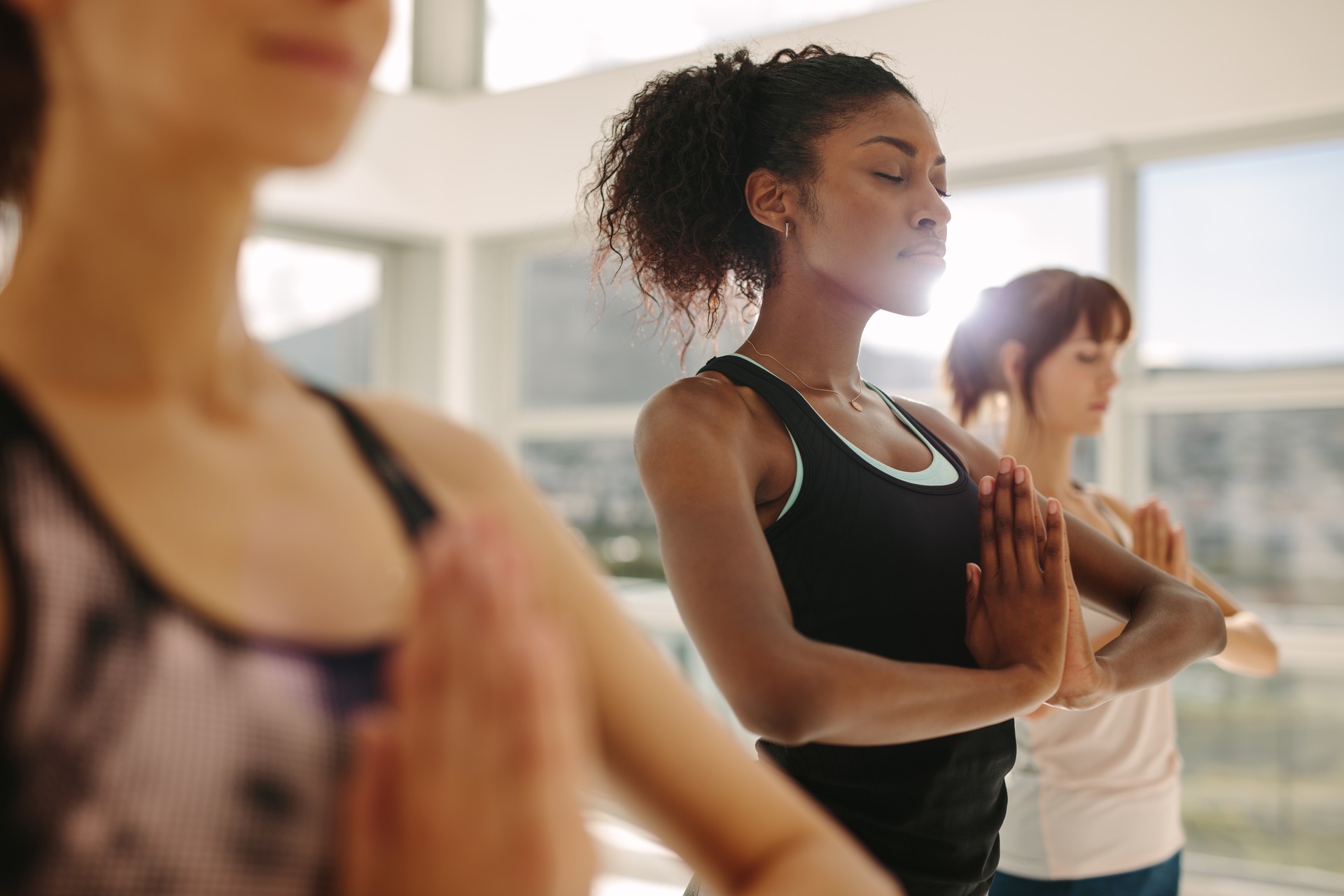 Woman practice yoga with friends in gym