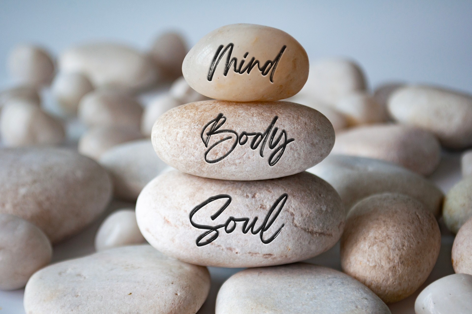 Mind, Body and soul text engraved on white zen stones